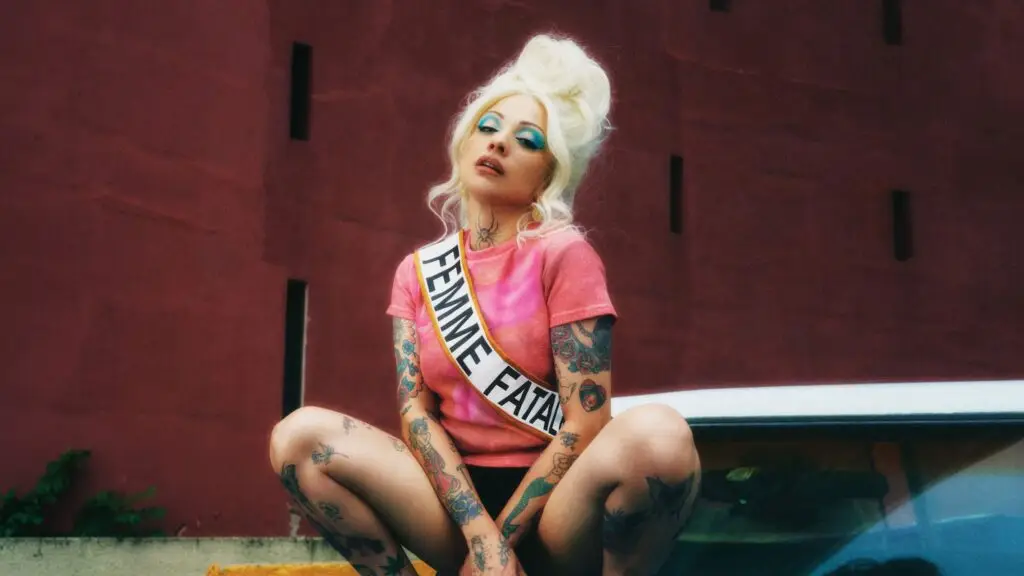 Mon Laferte poses in a 'Femme Fatale' sash during the Femme Fatale Tour 2026