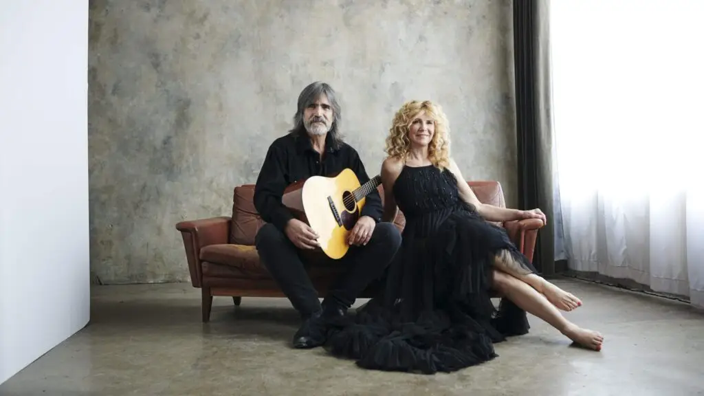 Larry Campbell and Teresa Williams seated with acoustic guitar, official press photo