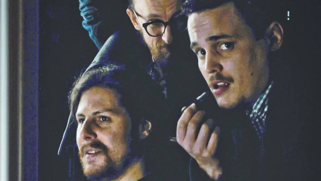 The Yawpers, three-piece Denver rock band, in a dark moody press portrait