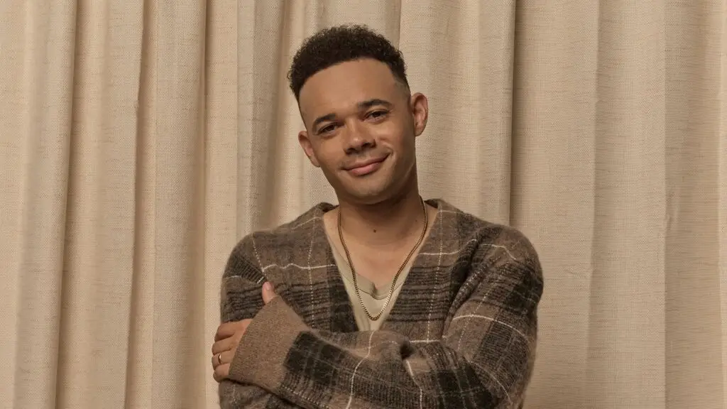 Tauren Wells smiling with arms crossed, contemporary Christian artist, press photo