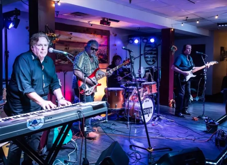 Inside Out four-piece band performing live on stage with keyboard, bass guitar, drums, and lead guitar