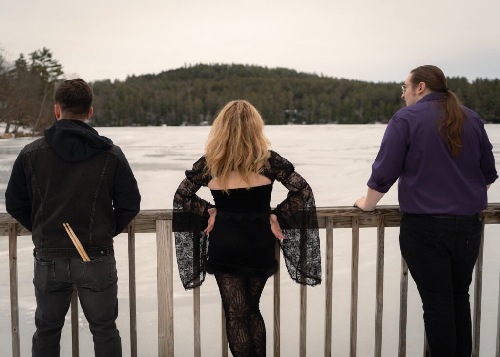 Lucid Street band members in a promotional photo overlooking a frozen winter lake