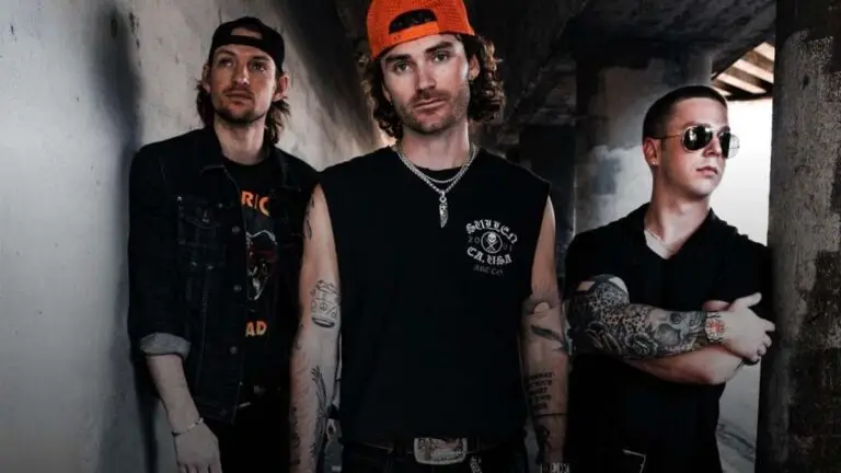 Eddie and the Getaway, three-piece band in industrial corridor — Eddie Eberle center in orange cap