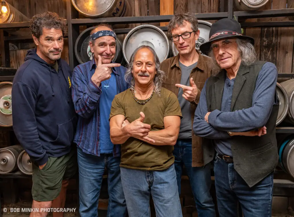 Skeleton Crewe Quintet press photo: five musicians pose together in a keg room