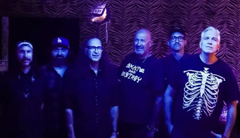 VooDoo Glow Skulls six-piece skacore band in their 2024 press photo at a venue with purple stage lighting