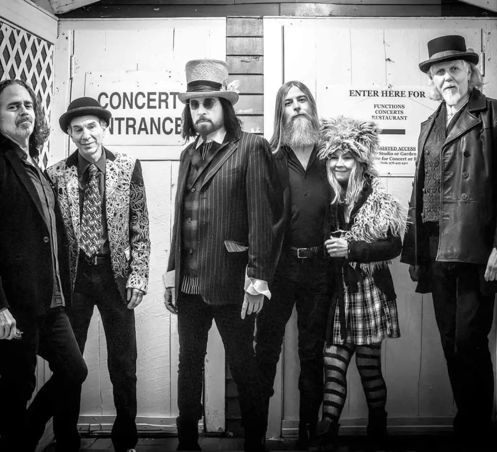Slambovian Circus of Dreams six-piece band in theatrical costumes outside a concert entrance