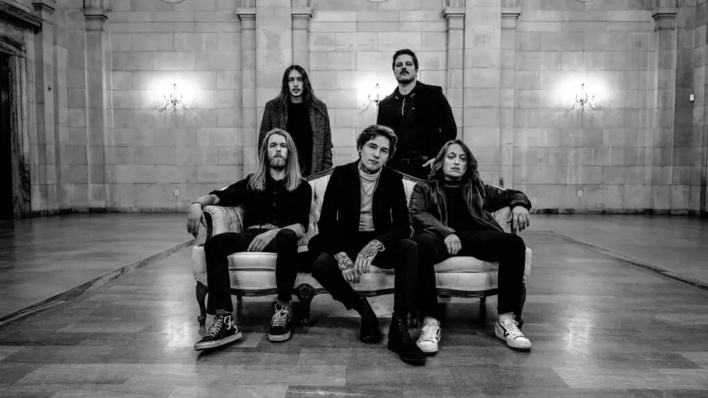 Midwinter metalcore five-piece in dramatic B&W press photo, marble hall setting