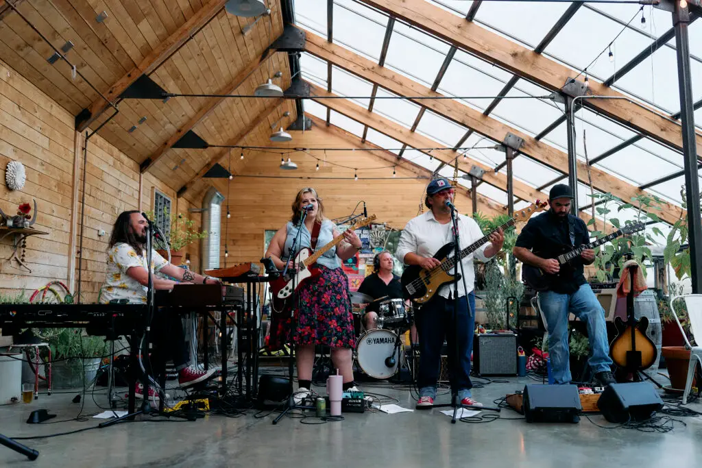 Noon Fifteen performing live at Stonebend Nursery, Ithaca — five-piece with female vocalist, keyboards, guitar, bass, and drums