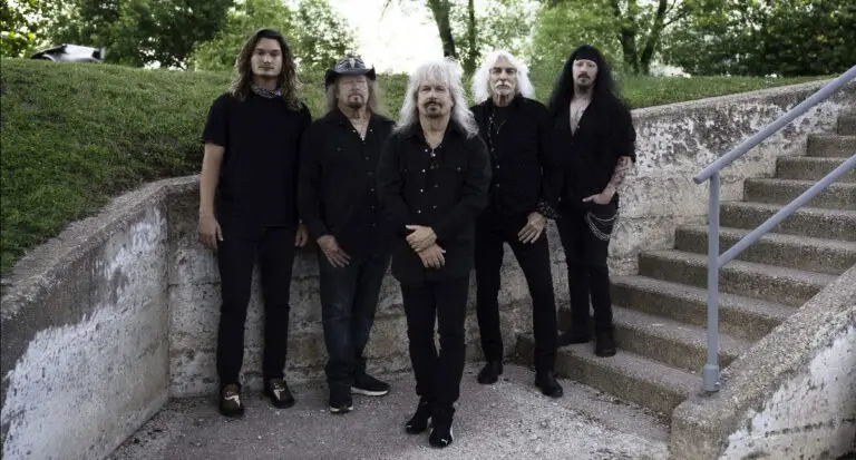 Molly Hatchet five-piece Southern rock band poses on stone outdoor steps, 2026 Lost Horizon tour press photo