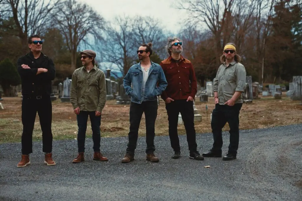 Whiskey Treaty Roadshow members posed in a late-winter cemetery setting, 2026 press photo