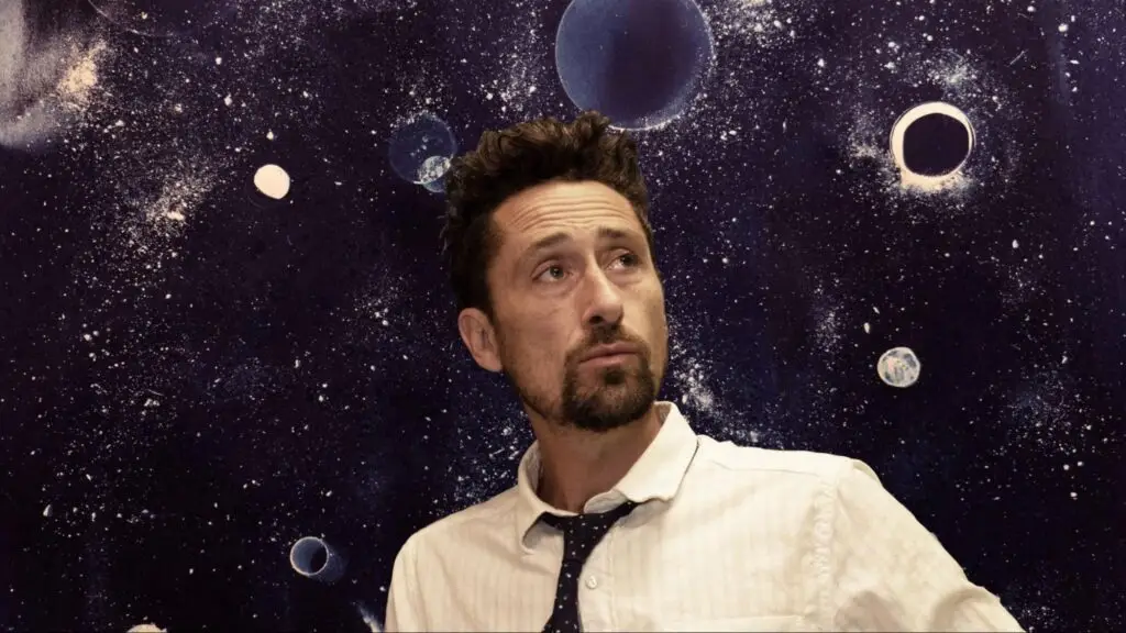 The Suitcase Junket (Matt Lorenz) press photo against cosmic starfield backdrop