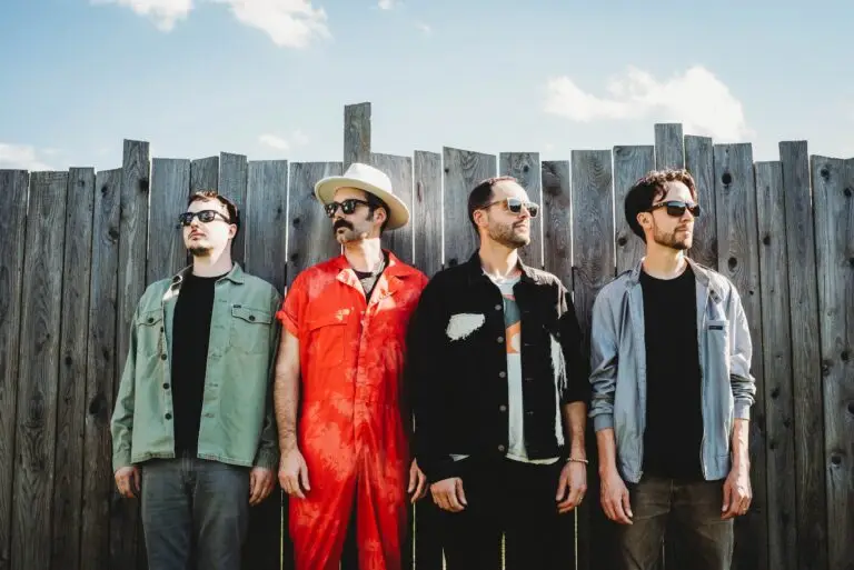 Jimkata band members pose in front of a wooden fence for their 2024 press photo