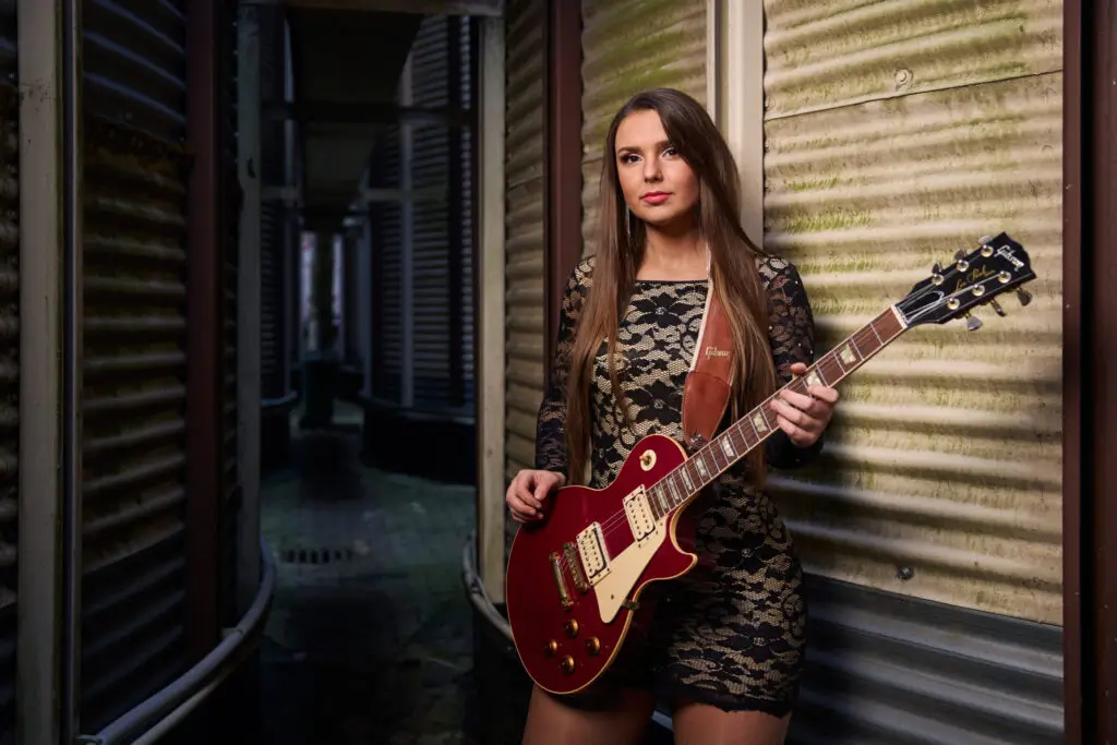 Ally Venable with her Gibson Les Paul guitar, official press photo