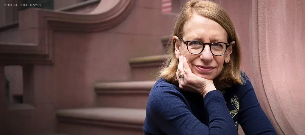 Roz Chast, New Yorker cartoonist, seated on brownstone steps in New York City