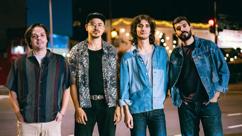 Eggy band members standing on a night street with city lights, promotional photo