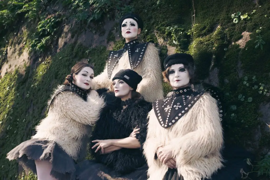 Dakh Daughters in signature white face paint and theatrical fur costumes, Ukraine Fire ensemble