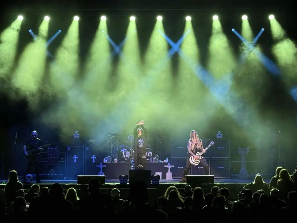 Crazy Train Ozzy tribute band performing live on stage with theatrical fog, green lighting, and skull props