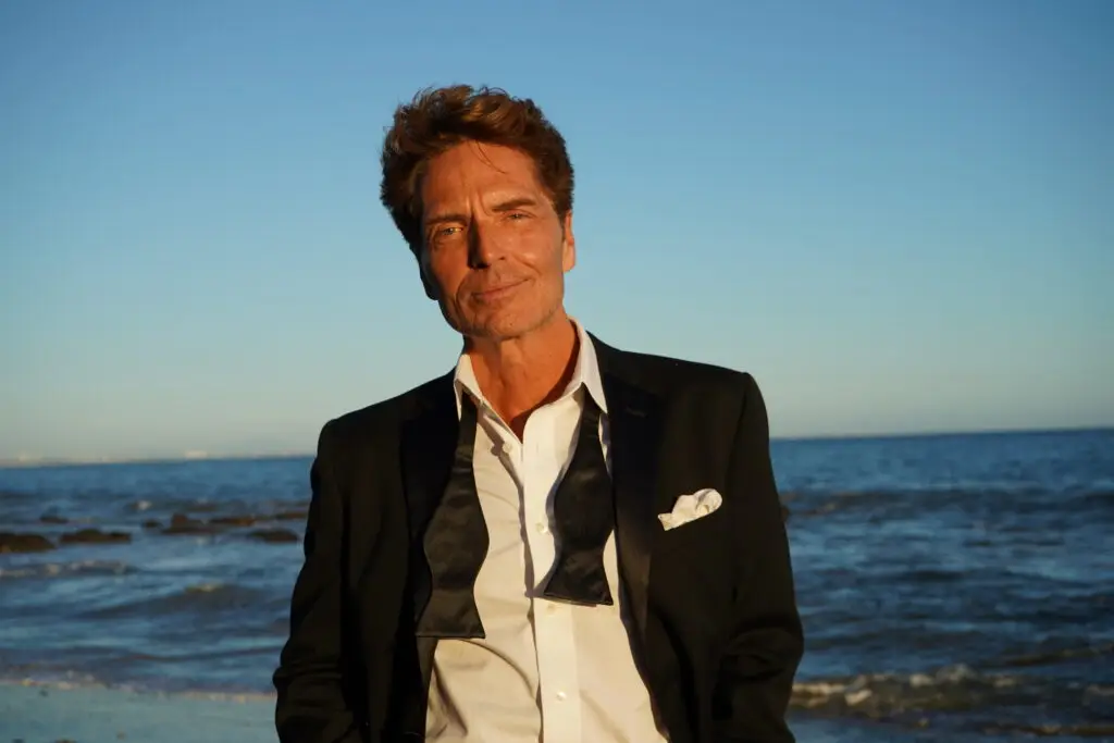 Richard Marx in black tuxedo with loosened bow tie at oceanside, press photo for his After Hours Tour