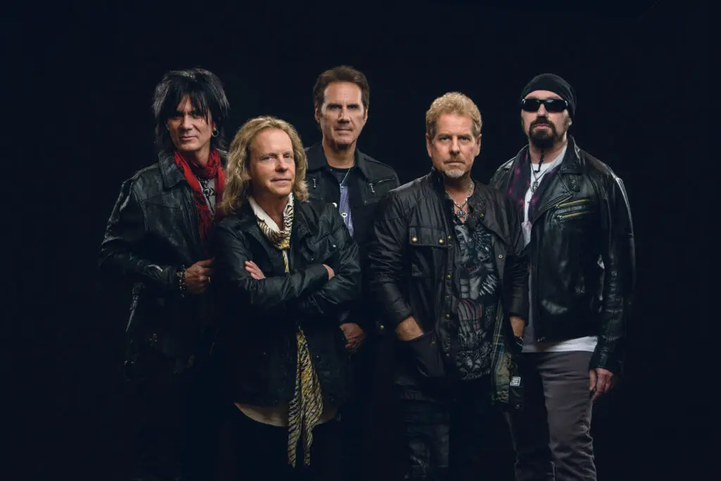 Night Ranger official press photo — five-piece rock band in leather against dark background