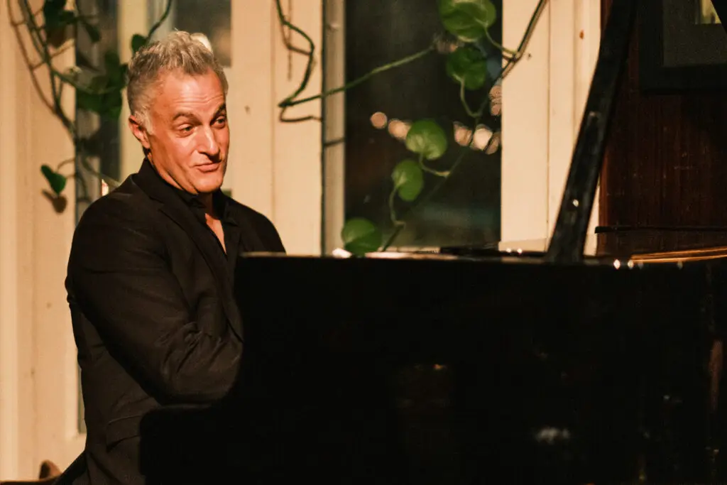 Eric Mintel performs at grand piano during an intimate live jazz concert