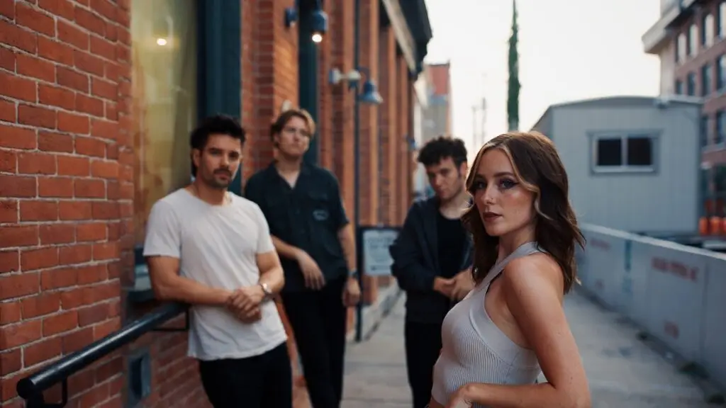 First To Eleven promotional photo — vocalist Audra Miller and bandmates in an urban alley setting