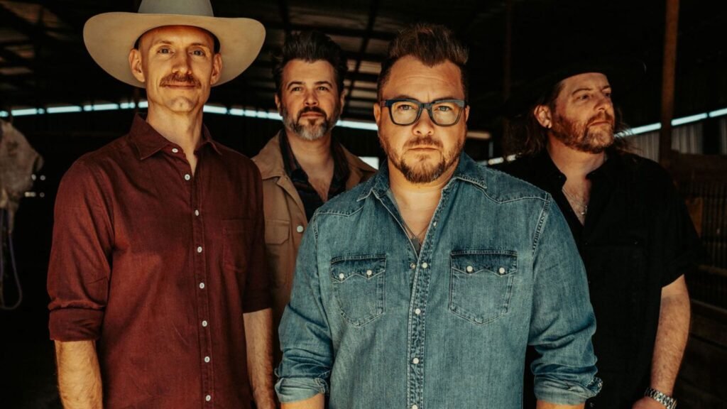 Eli Young Band — Mike Eli, James Young, Jon Jones, and Chris Thompson in a rustic barn setting