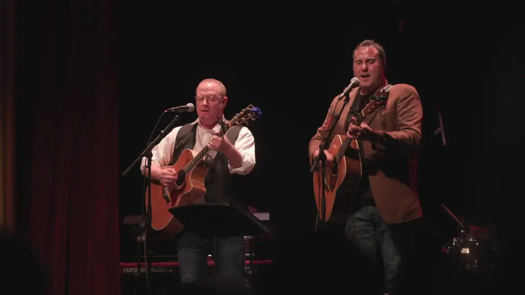 On Bleecker Street duo performs live on stage with acoustic guitars