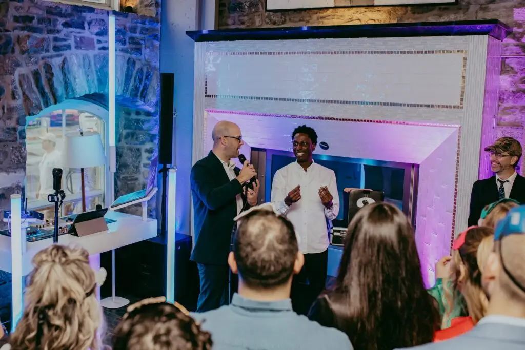 Michael Bourada performing live magic with audience participant at corporate event