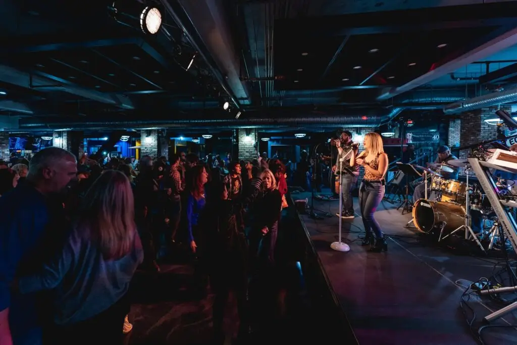 Grand Central Station Band performing live, vocalist Kelly Nolan at center stage, crowd dancing