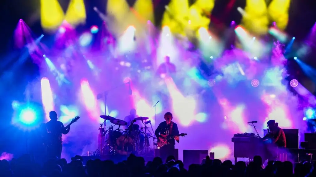 Trey Anastasio Band performing live on stage under dramatic concert lighting