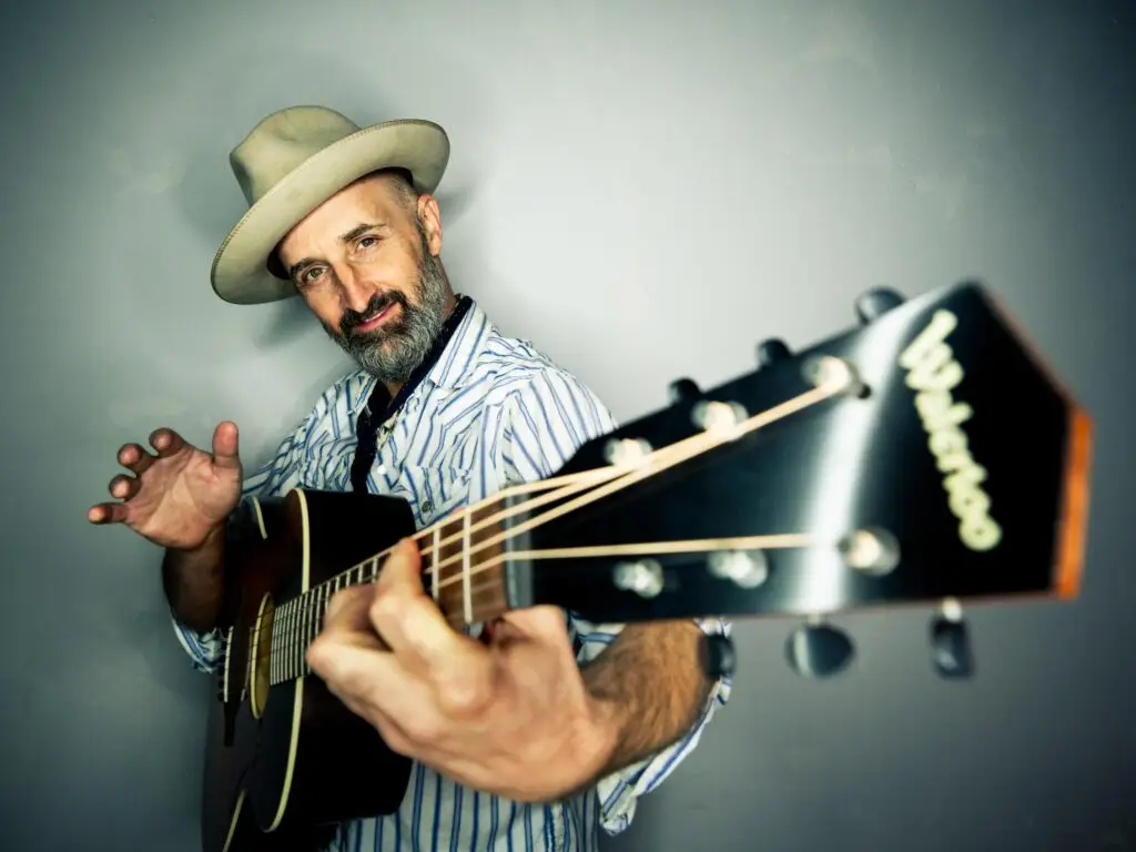 Seth Walker performing with acoustic guitar, Americana singer-songwriter at Colony Woodstock November 2026