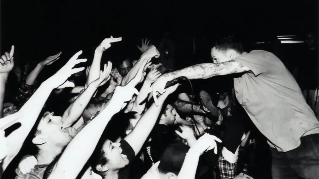 I Am the Avalanche frontman Vinnie Caruana leans into the crowd during a live performance