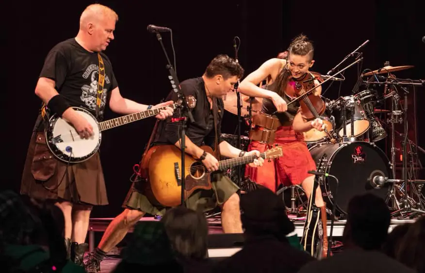 The Town Pants performing live Celtic roots-rock — banjo, guitar, and violin at front of stage