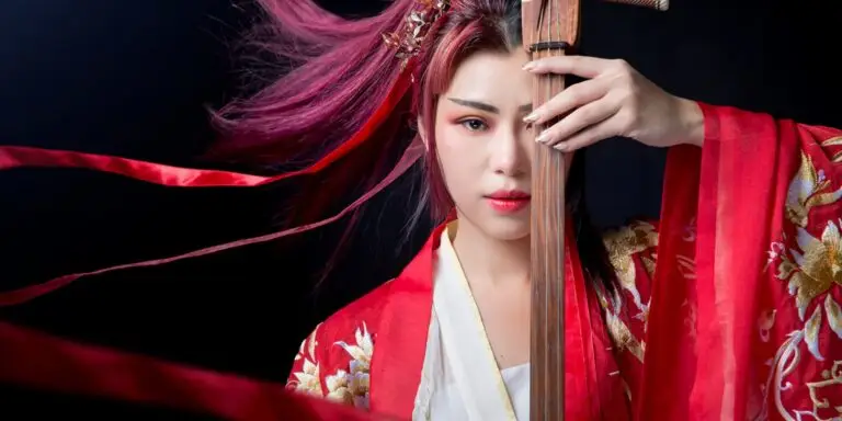 NiNi playing traditional Chinese Ruan instrument in embroidered red hanfu robe