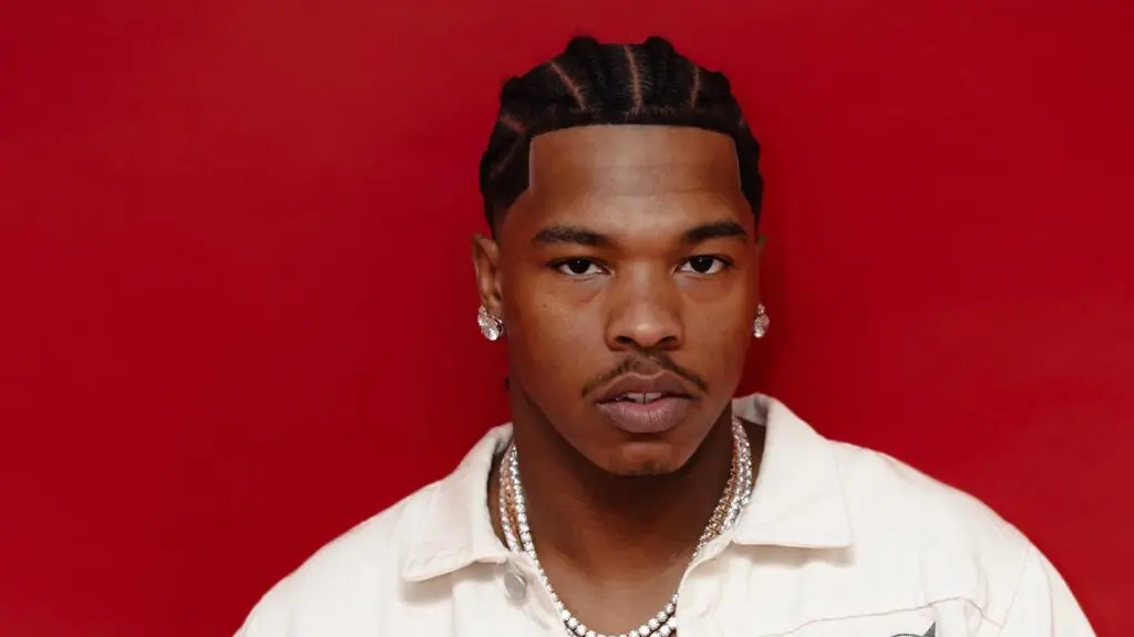 Lil Baby, rapper, in official promotional photo against red background
