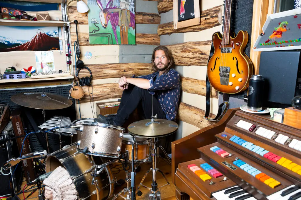 Marco Benevento in his studio surrounded by vintage organs, drums, guitar, and a Casio keyboard