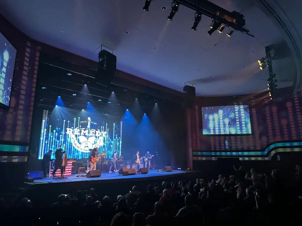 Remedy - A Black Crowes Tribute performing live on stage, LED band logo backdrop lit behind the full seven-piece lineup