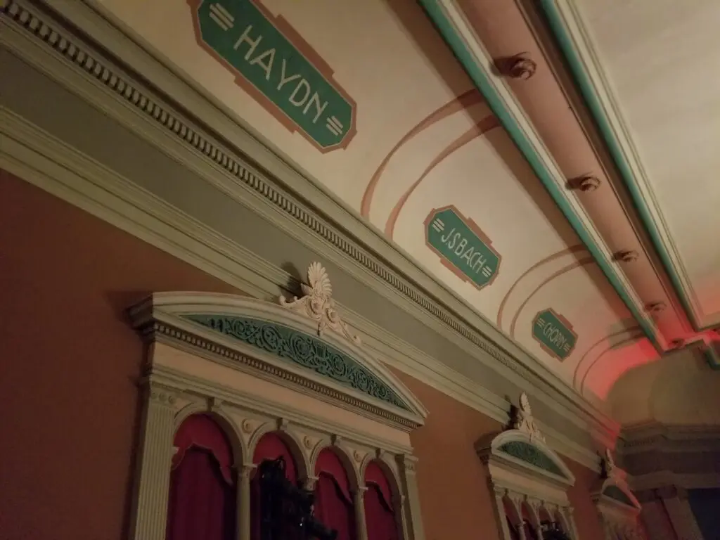 Ceiling detail at Troy Savings Bank Music Hall showing painted cartouches naming Haydn, J.S. Bach and Gounod