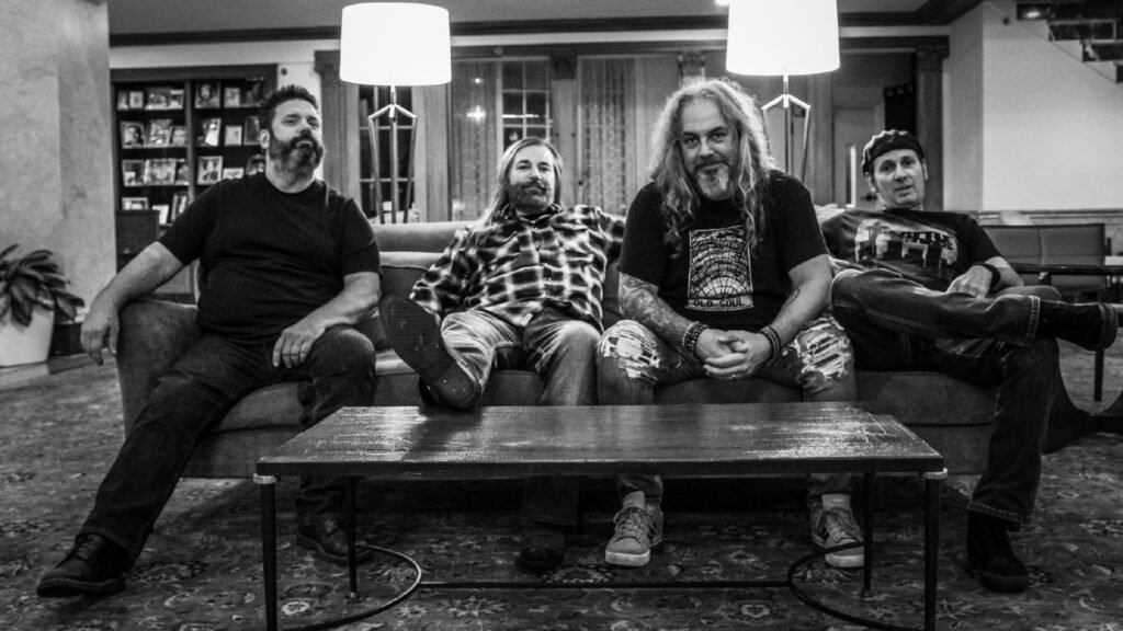 Seattle Sons, Central NY grunge tribute quartet, seated in hotel lounge for band press photo