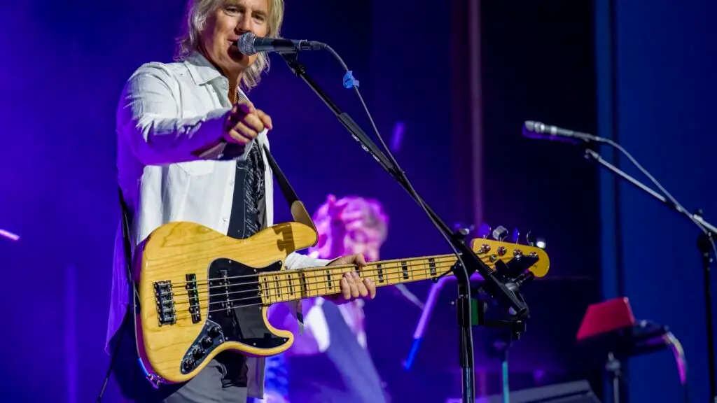 The Players performing live — Jeff Coffey on bass and vocals, purple stage lighting