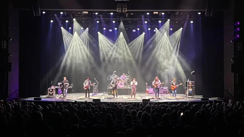 EagleMania performing live, seven-piece Eagles tribute band on stage with theatrical lighting
