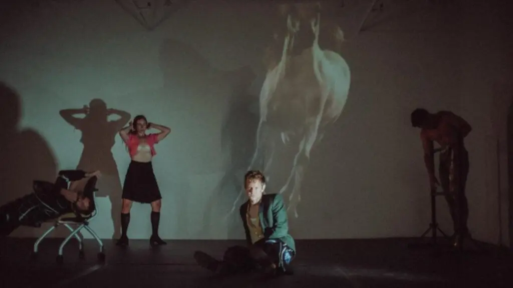 Perfume Genius and Kate Wallich perform The Lesson on stage with a large horse projection on the rear wall