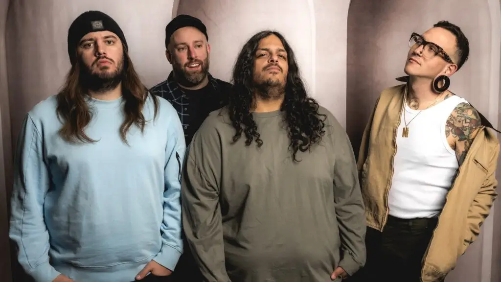 Keep Flying punk band in official press photo, four members posed against neutral arched backdrop