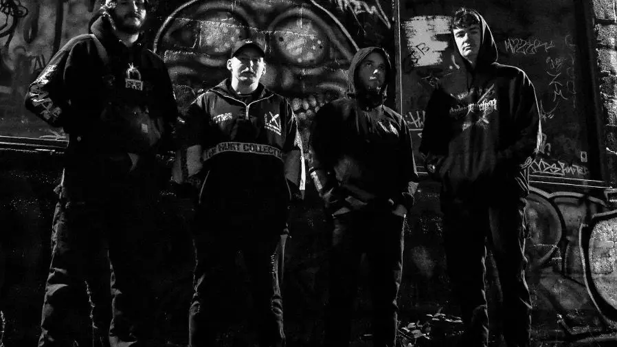 9MM Mouthwash band members in a black-and-white promo photo in front of a graffiti wall