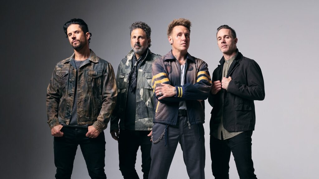 Papa Roach band members in official press photo, Jacoby Shaddix center in yellow-stripe jacket
