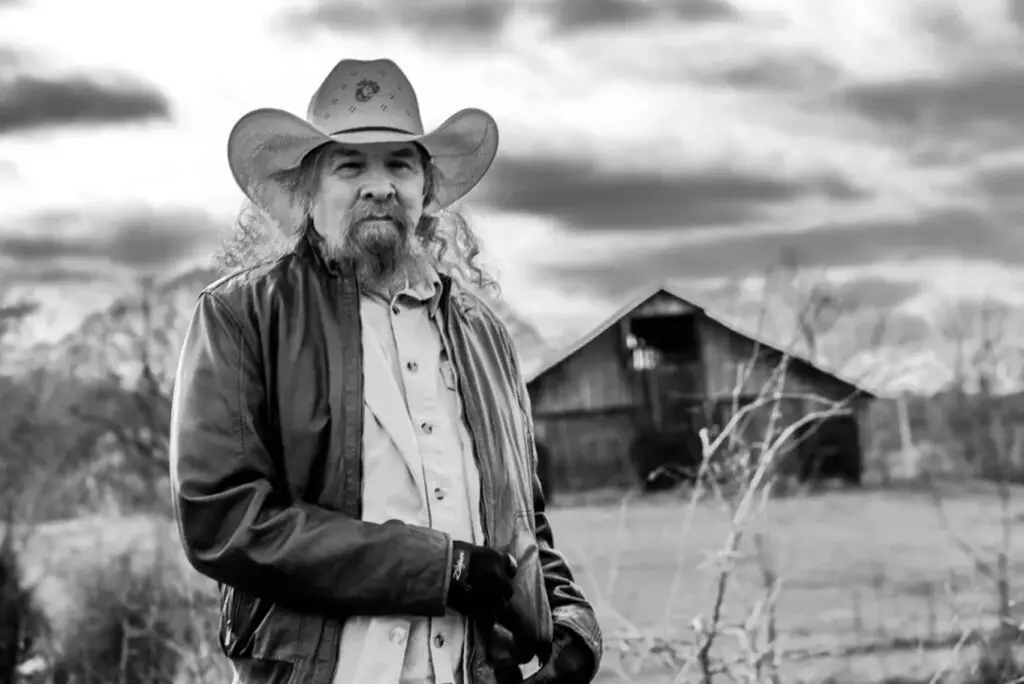 Artimus Pyle, Rock & Roll Hall of Fame drummer, in an outdoor black-and-white press photo holding drumsticks