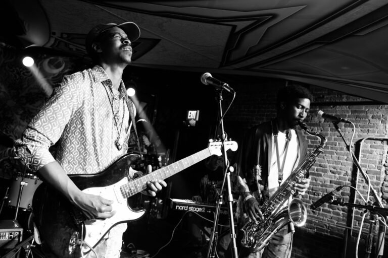 Ky McClinton Band performing live at Ophelia's in Albany, guitarist and saxophonist on stage