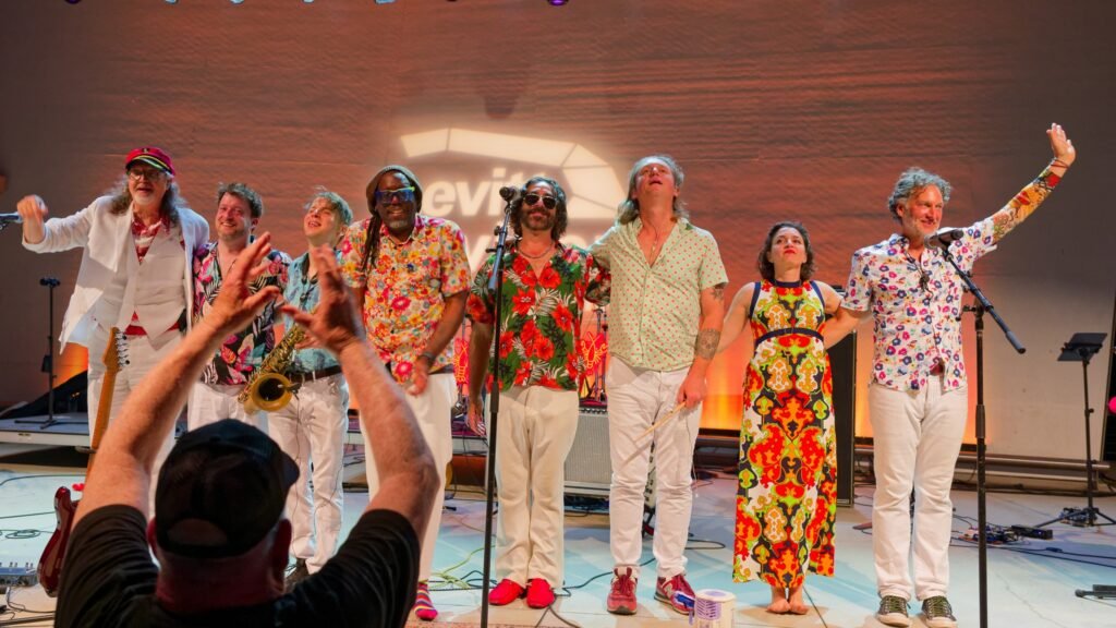 Yacht Lobsters performing live on stage, full band in tropical shirts taking a bow