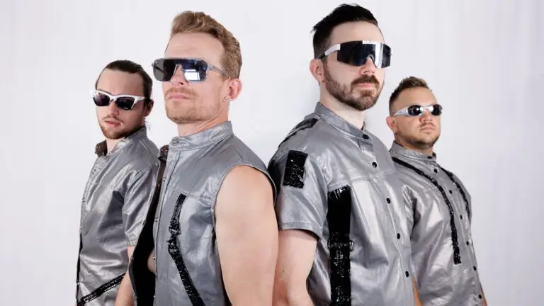 Fool House band in matching silver outfits and futuristic sunglasses, promotional photo