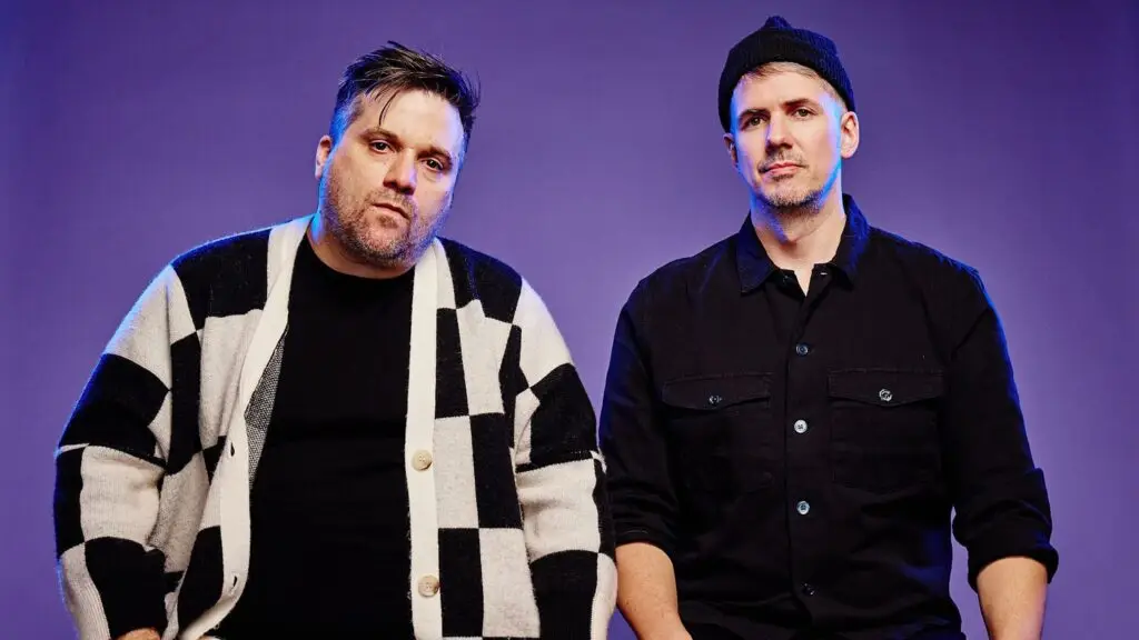 Walker & Royce electronic duo in official press photo against purple studio backdrop